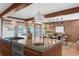 Spacious kitchen featuring a concrete island, wood cabinets, and stainless steel appliances with breakfast nook at 6110 E 6Th Avenue Pkwy, Denver, CO 80220