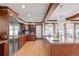 Open concept kitchen with stainless steel appliances, an island with seating, and wood cabinets at 6110 E 6Th Avenue Pkwy, Denver, CO 80220