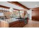 Open concept kitchen featuring a concrete island, dining area, stainless steel appliances, and wood cabinets at 6110 E 6Th Avenue Pkwy, Denver, CO 80220