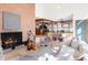 Inviting living room with a brick fireplace, comfortable seating, and an open view into the kitchen area at 6110 E 6Th Avenue Pkwy, Denver, CO 80220