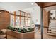 Bright living room featuring a brick planter, large windows, hardwood floors, and modern furnishings at 6110 E 6Th Avenue Pkwy, Denver, CO 80220