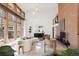 Bright living room featuring floor-to-ceiling windows, modern furniture, and a prominent brick fireplace at 6110 E 6Th Avenue Pkwy, Denver, CO 80220