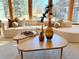 Living room featuring a curved couch, wood floors and artistic coffee table decor at 6110 E 6Th Avenue Pkwy, Denver, CO 80220