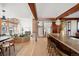 Open-concept living space showcasing hardwood floors, a brick planter, and a kitchen island with bar seating at 6110 E 6Th Avenue Pkwy, Denver, CO 80220
