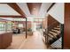 Expansive living space with hardwood floors, exposed beams, brick accents, and plenty of natural light at 6110 E 6Th Avenue Pkwy, Denver, CO 80220