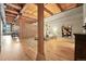 The open bedroom area has hardwood floors, exposed beams, and a partial brick wall at 2955 Inca St # 2D, Denver, CO 80202