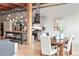 Dining area and kitchen with stainless steel appliances, island with seating, and modern light fixtures at 2955 Inca St # 2D, Denver, CO 80202