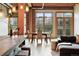 Dining area with natural light, exposed brick accents, wood beam ceilings, and comfortable seating at 2955 Inca St # 2D, Denver, CO 80202