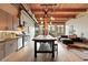 Open kitchen design with stainless steel appliances, large island, and exposed wood beams for a loft feel at 2955 Inca St # 2D, Denver, CO 80202