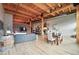Open living space with wood floors, exposed beams, brick wall, dining area, and modern kitchen at 2955 Inca St # 2D, Denver, CO 80202