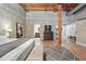 Spacious main bedroom with wood floors, exposed wood beam and ensuite bathroom at 2955 Inca St # 2D, Denver, CO 80202