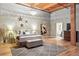 Large primary bedroom featuring wood floors, exposed wood beam and chandelier at 2955 Inca St # 2D, Denver, CO 80202