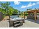 Backyard features a private hot tub, an outdoor gazebo with seating, and mature landscaping at 6505 W Hampden Ave, Lakewood, CO 80227