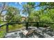 Serene backyard deck overlooking a pond and lush greenery, perfect for relaxing outdoors at 6505 W Hampden Ave, Lakewood, CO 80227