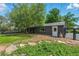 Charming backyard featuring a deck, mature trees, privacy fence, and a detached garage at 6505 W Hampden Ave, Lakewood, CO 80227