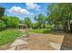 Spacious backyard with a lush lawn, mature trees, a gazebo and a flagstone walkway at 6505 W Hampden Ave, Lakewood, CO 80227