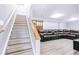 Finished basement with a large sectional, wood-look floors, and a sliding barn door at 6505 W Hampden Ave, Lakewood, CO 80227