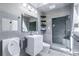 Modern bathroom with gray tile, walk-in shower, and a vessel sink vanity at 6505 W Hampden Ave, Lakewood, CO 80227