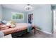 Bedroom with hardwood floors, a closet, and a bright window with a view at 6505 W Hampden Ave, Lakewood, CO 80227