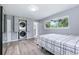 Bedroom with hardwood floors, a built-in washer and dryer, and a sunlit window at 6505 W Hampden Ave, Lakewood, CO 80227