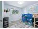Cozy bedroom with wood-look floors, a bright window, and a playful map at 6505 W Hampden Ave, Lakewood, CO 80227