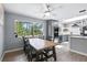Spacious dining area with gray walls, a large window, and access to the modern kitchen at 6505 W Hampden Ave, Lakewood, CO 80227