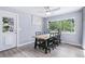 Charming dining room with a wooden table, black chairs, and a large window offering natural light at 6505 W Hampden Ave, Lakewood, CO 80227