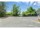 Wide paved driveway and parking area leading to a home at 6505 W Hampden Ave, Lakewood, CO 80227