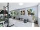 Exercise room with windows offering an outdoor view, plus a treadmill and weight rack at 6505 W Hampden Ave, Lakewood, CO 80227