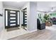 Bright foyer with modern tile flooring and a stylish front door leading into the living spaces at 6505 W Hampden Ave, Lakewood, CO 80227