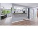 Bright living space with an open view of a modern kitchen featuring sleek countertops at 6505 W Hampden Ave, Lakewood, CO 80227