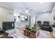Open living room area with a fireplace, seating, and view into the modern kitchen at 6505 W Hampden Ave, Lakewood, CO 80227