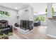 Spacious room with fireplace and dining area, featuring hardwood floors and natural light at 6505 W Hampden Ave, Lakewood, CO 80227