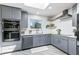 Corner view of a modern kitchen featuring stainless steel appliances and stylish lighting fixtures at 6505 W Hampden Ave, Lakewood, CO 80227