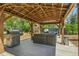 Outdoor living space features an open structure, outdoor furniture and a stainless gas grill at 6505 W Hampden Ave, Lakewood, CO 80227
