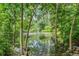 Picturesque pond with fountain feature, surrounded by mature trees and lush greenery at 6505 W Hampden Ave, Lakewood, CO 80227