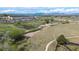 Scenic aerial shot of community grounds featuring green spaces, trails and a large building with ample parking at 11427 King Way, Westminster, CO 80031