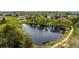Picturesque aerial view of a tranquil pond surrounded by trees and a paved walking path at 11427 King Way, Westminster, CO 80031