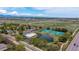 Beautiful aerial view featuring a community pool, tennis courts, and a scenic pond at 11427 King Way, Westminster, CO 80031