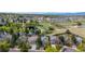 Aerial view of a neighborhood highlighting residential homes, green spaces, and a nearby pond at 11427 King Way, Westminster, CO 80031