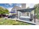 Inviting backyard with patio, dining area, manicured lawn, and a hot tub under a pergola at 11427 King Way, Westminster, CO 80031