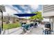 Beautifully designed backyard patio features blue furniture, dining, and firepit area at 11427 King Way, Westminster, CO 80031