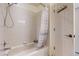 Bathroom with a white tiled shower and tub combination with a patterned shower curtain at 11427 King Way, Westminster, CO 80031