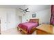Bedroom with a ceiling fan, a full-sized bed, and dual doors leading to other spaces at 11427 King Way, Westminster, CO 80031