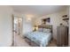 Bedroom features a bed, bedside table with lamp, and decor; bathroom and hallway in background at 11427 King Way, Westminster, CO 80031