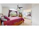 Bedroom with vaulted ceilings, a ceiling fan, large window, and wood furniture at 11427 King Way, Westminster, CO 80031