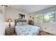 Comfortable bedroom featuring a bed, dresser, bedside table and window with a view at 11427 King Way, Westminster, CO 80031