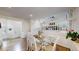 Bright dining room featuring hardwood floors and a modern glass table set for four guests at 11427 King Way, Westminster, CO 80031