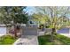 Inviting townhome featuring a stone facade, an attached garage, and a meticulously landscaped front yard at 11427 King Way, Westminster, CO 80031