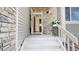 Inviting front porch featuring stone accents and a red front door for a charming curb appeal at 11427 King Way, Westminster, CO 80031